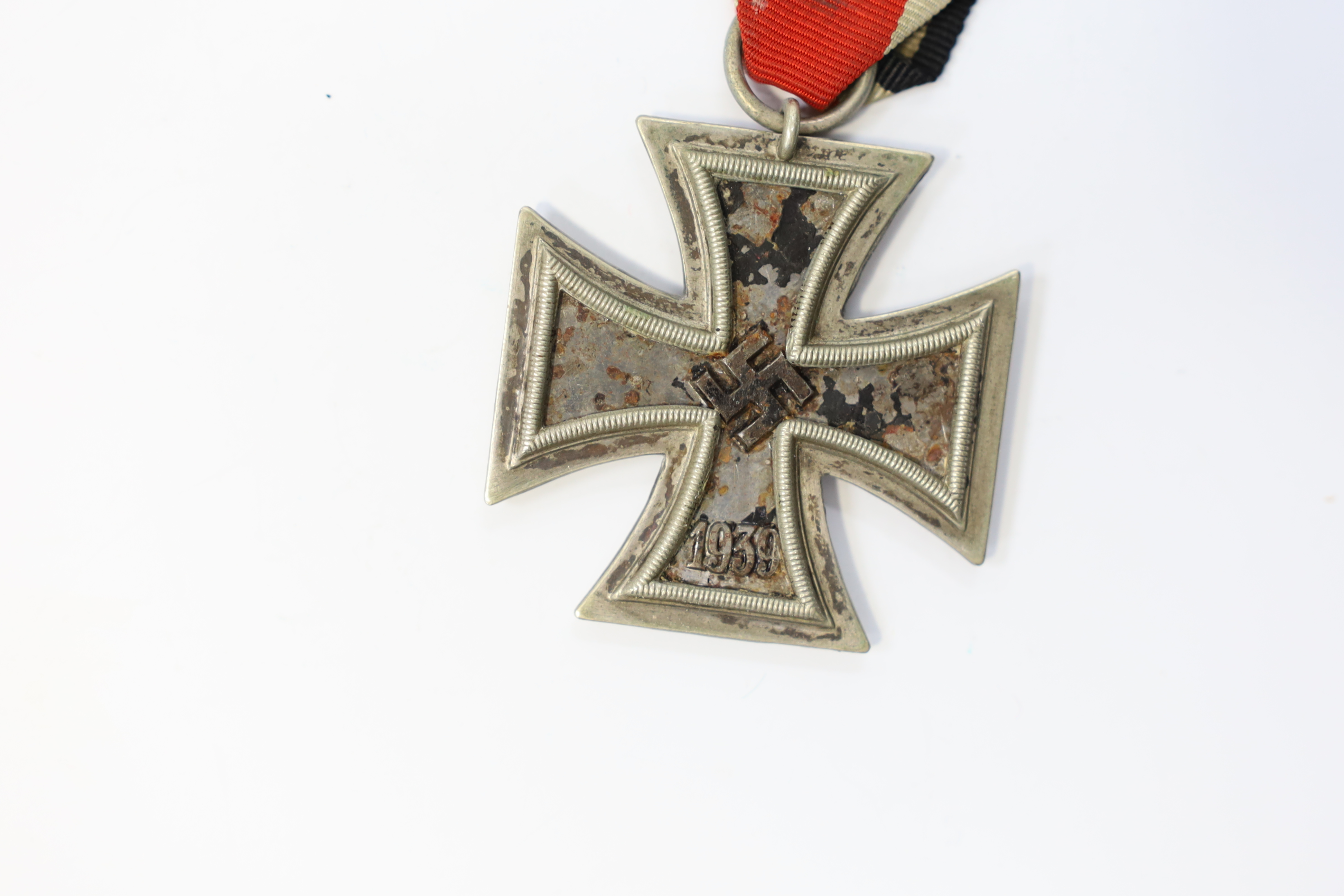 A WWII Iron Cross. Condition - poor, black paint now mainly missing from surface.